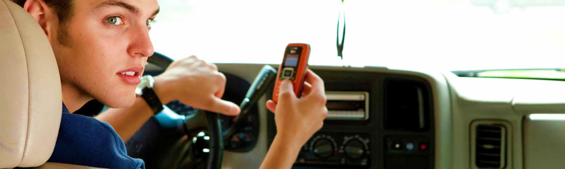 Private Vehicle for Half day with Driver Man texting on mobile phone while driving, distracted driving safety concept in vehicle interior